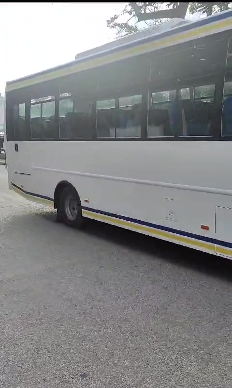 Large white bus turning onto the road