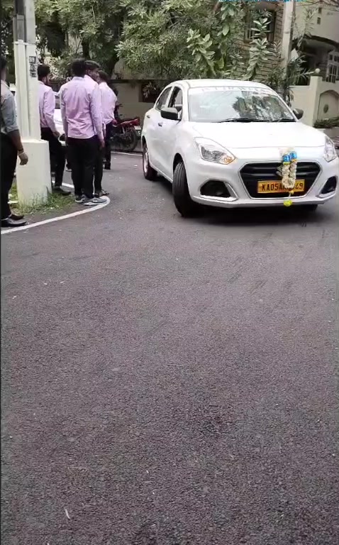 Newly inducted white sedan decorated with a garland