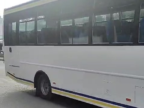 Large white bus with blue and yellow stripes from the fleet